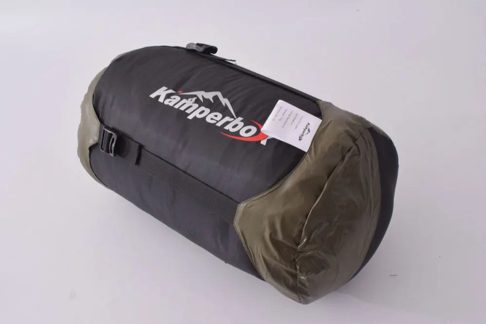 Black and brown sleeping bag with 'Kamperbox' branding on a white background