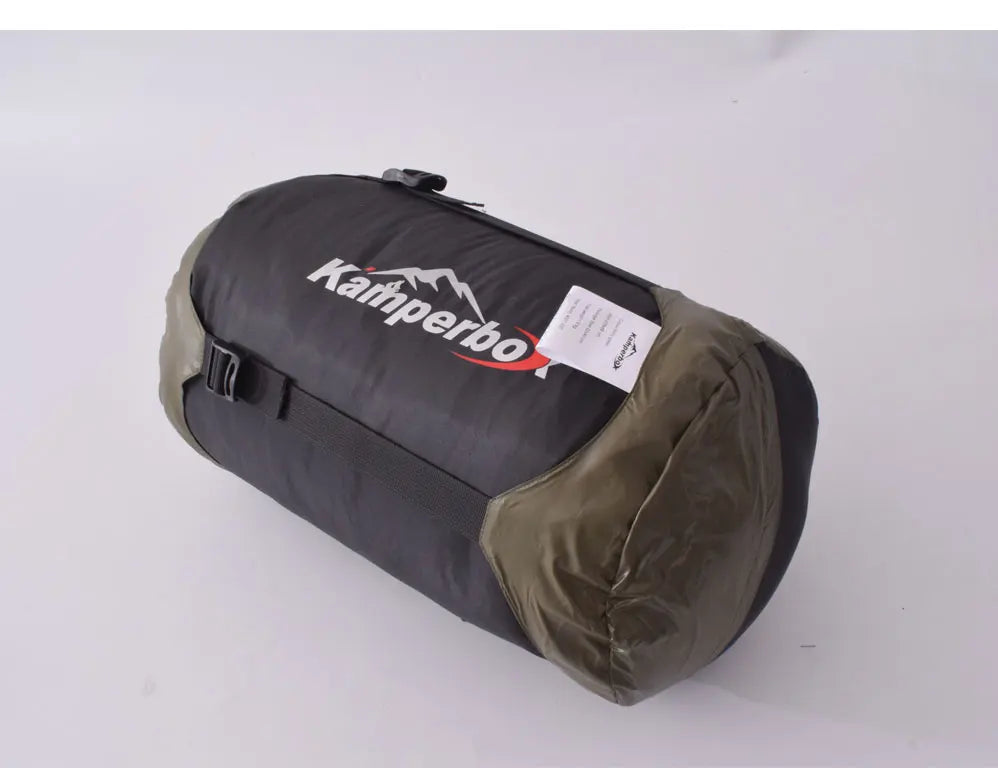 Black and brown sleeping bag with 'Kamperbox' branding on a white background