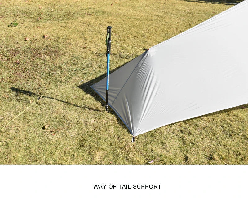 Camping tent with a pole on grass, labeled 'Way of Tail Support'.