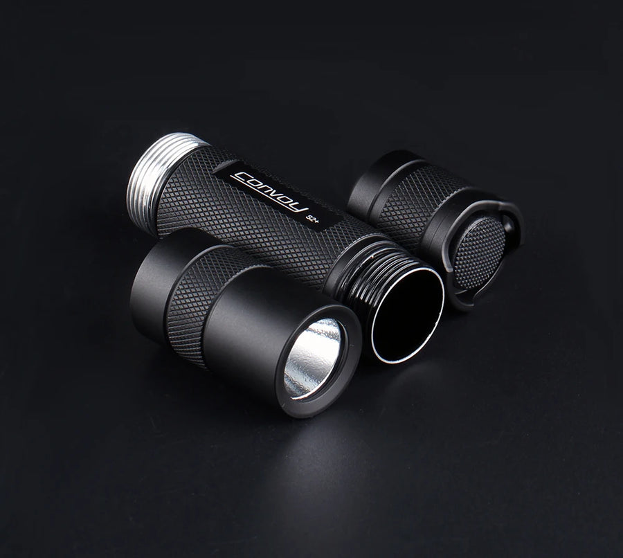 Black torch with a brand logo on a dark background