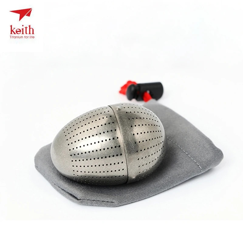 Metal tea ball with a gray cloth on a white background, featuring the Keith brand.