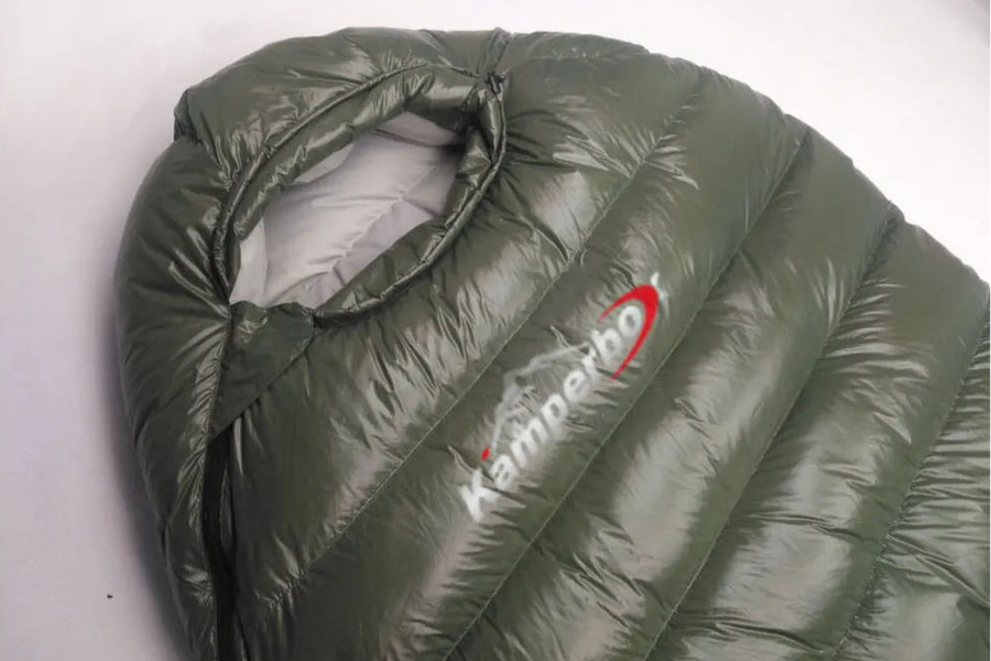 Green sleeping bag with Kamperbox logo on a white background