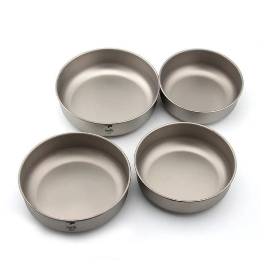 Four metallic bowls on a white background