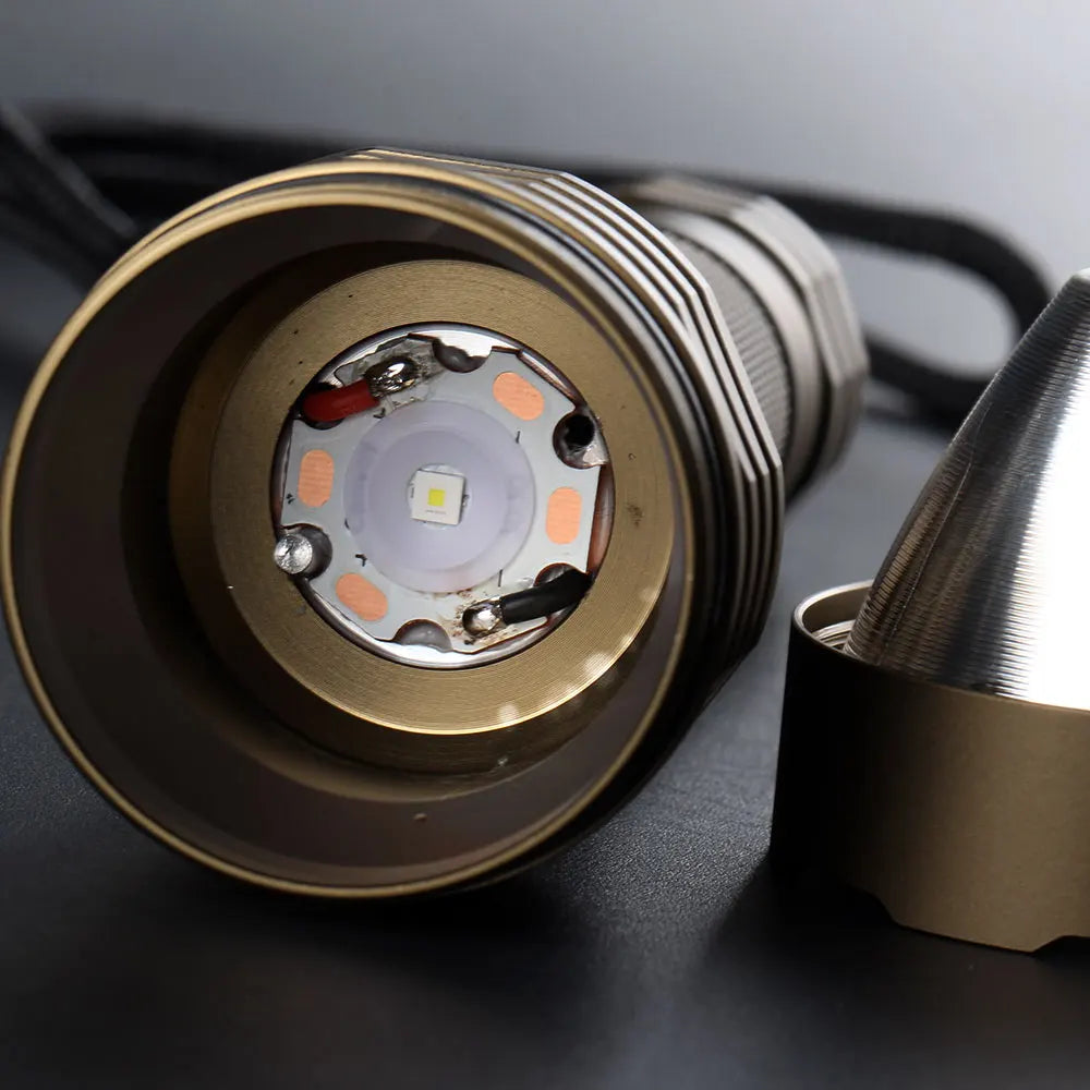 Close-up of a flashlight's internal components on a dark surface