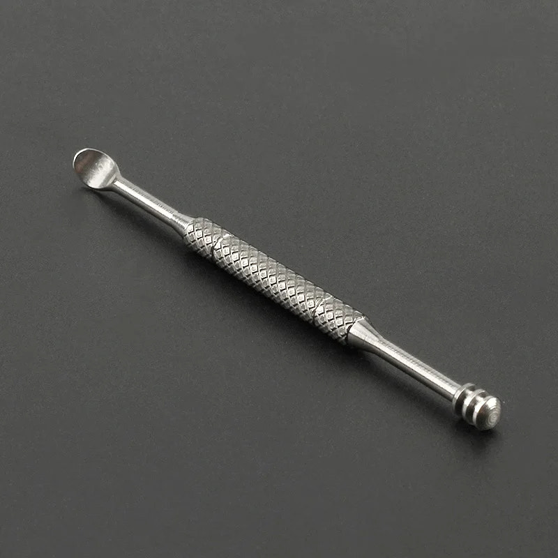 Metal tool with textured design on a dark gray background