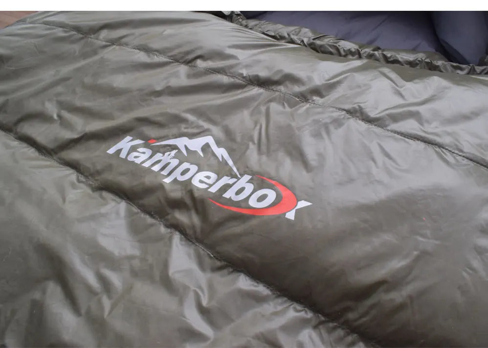 Green sleeping bag with Kampa logo on a plain background