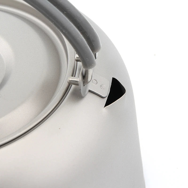Close-up of a titanium kettle with a gray handle on a white background