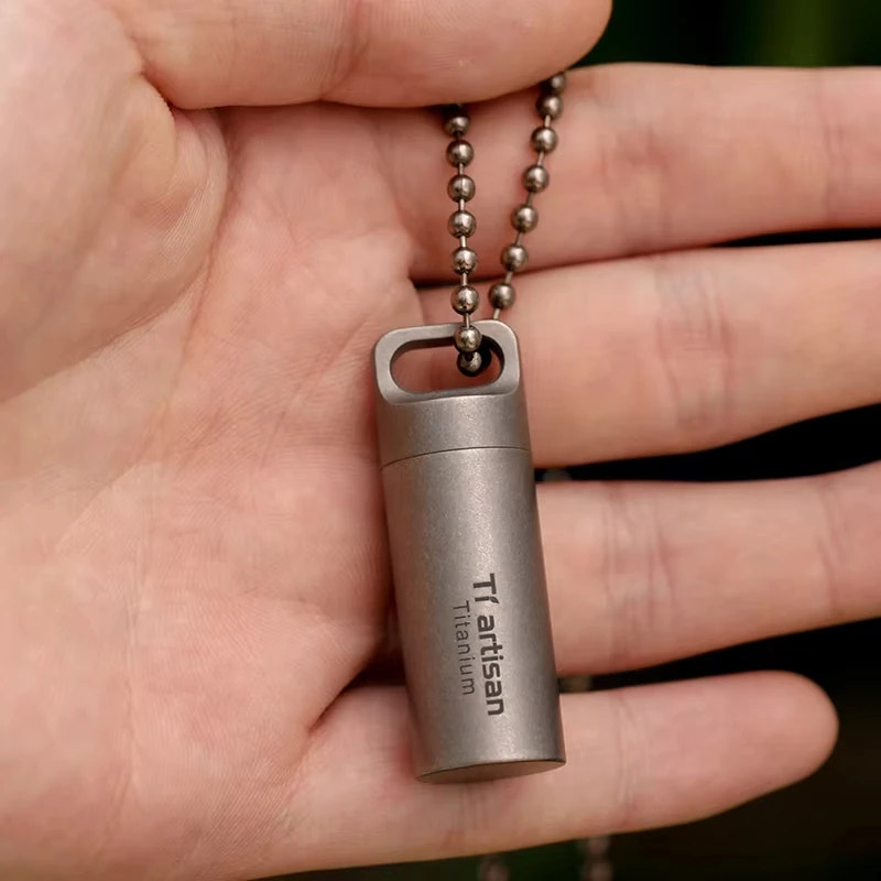 titanium bottle with chain held in a hand