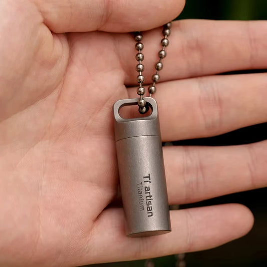 titanium bottle with chain held in a hand