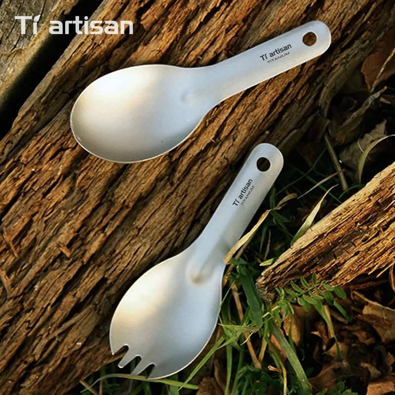 Two Tiartisan titanium spoons on a natural wooden and grass background