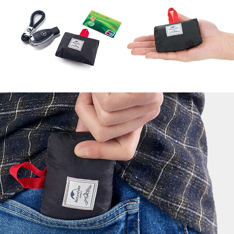 Black compact bag with red handle held by a hand, placed in a pocket, and shown with a keychain and card on a white background.