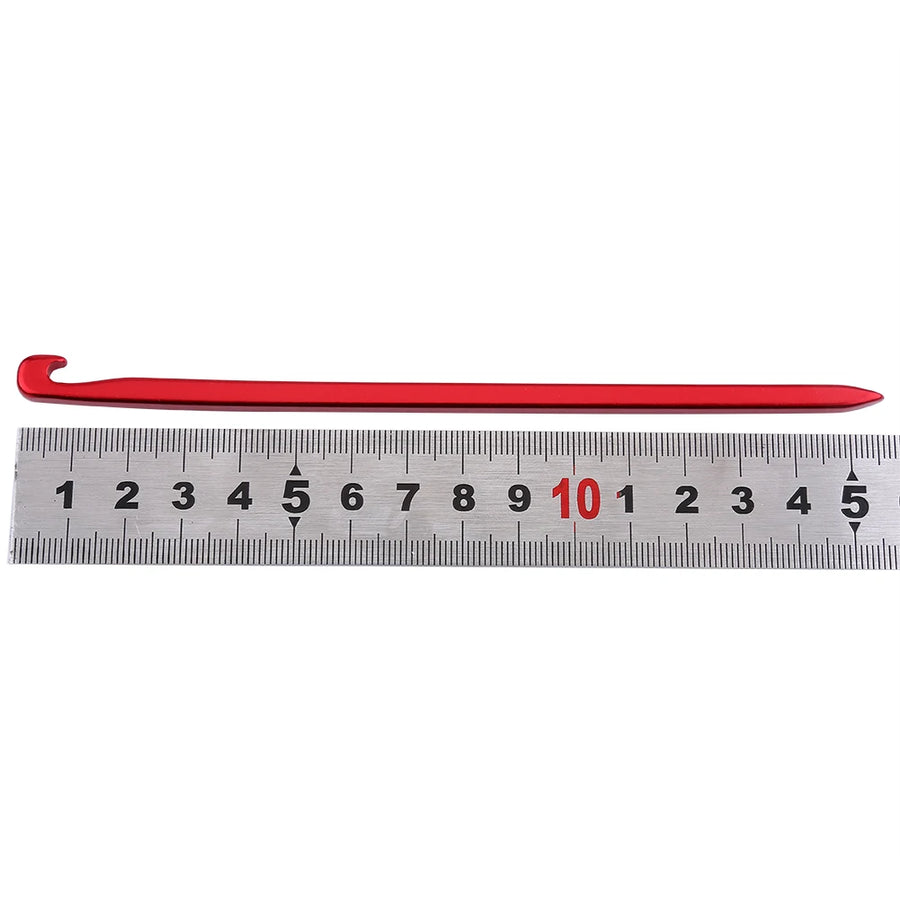 tent stake against ruler