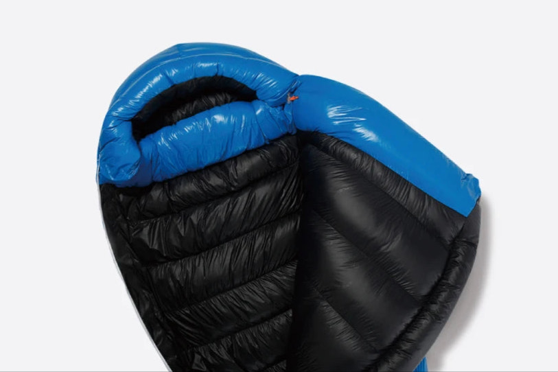 Black sleeping bag with blue interior on a white background