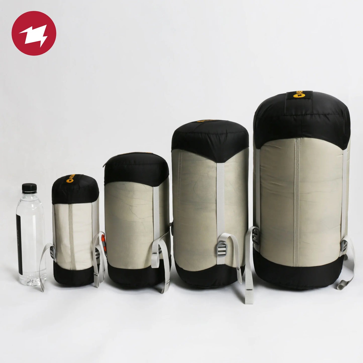 Set of four sleeping bags in different sizes on a white background