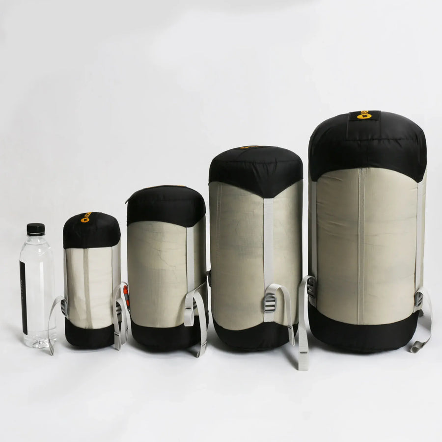 Set of four sleeping bags in different sizes on a white background