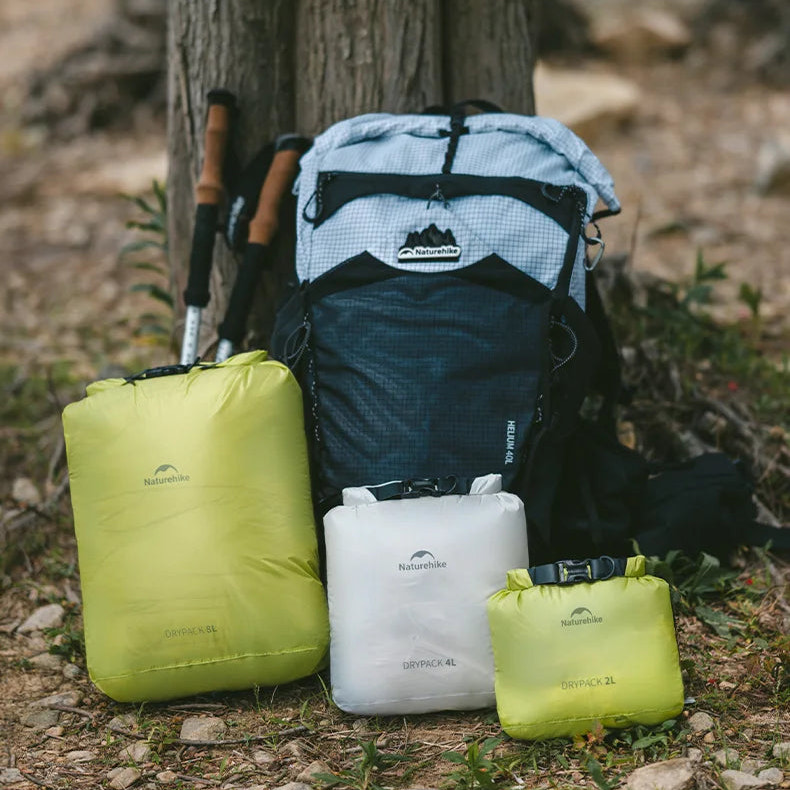 Backpack and organized storage bags against a tree with text about available sizes.