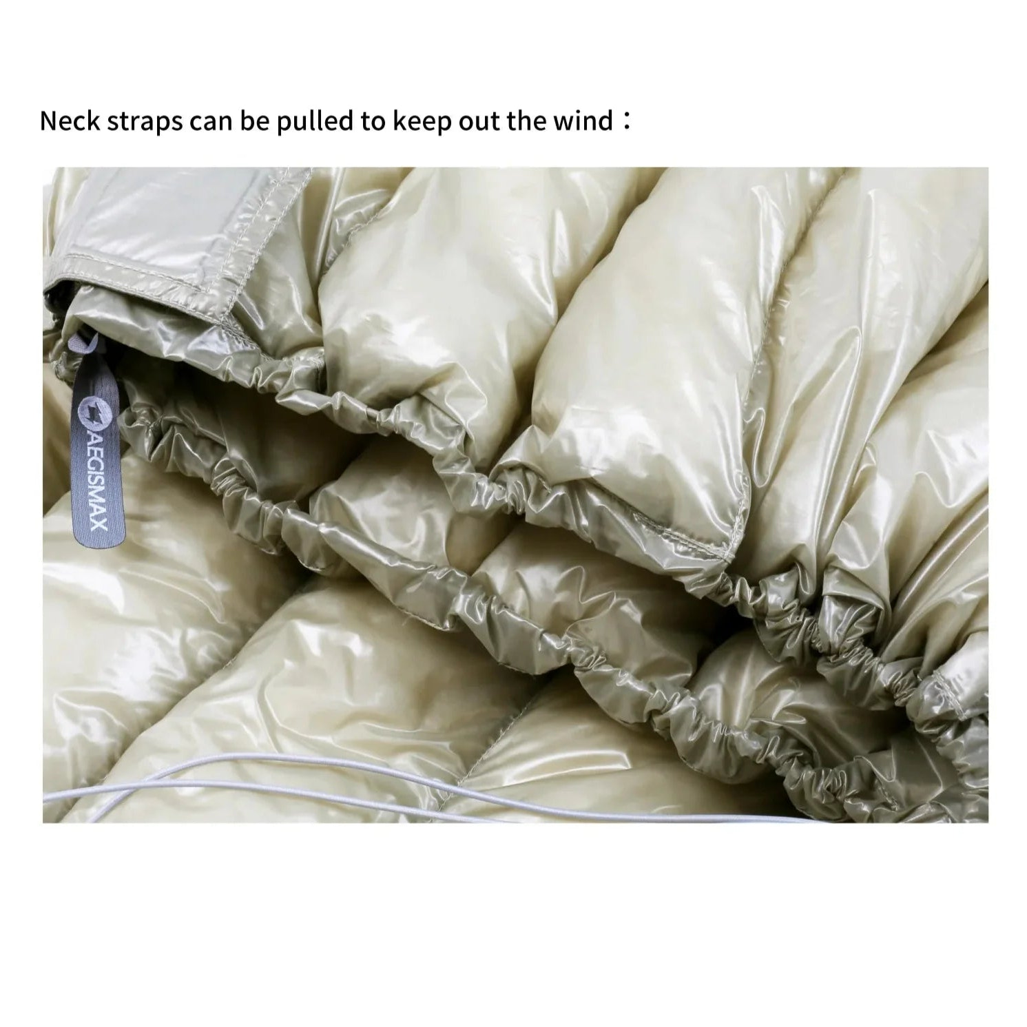Folded beige sleeping bag with neck straps and Aecon Max label