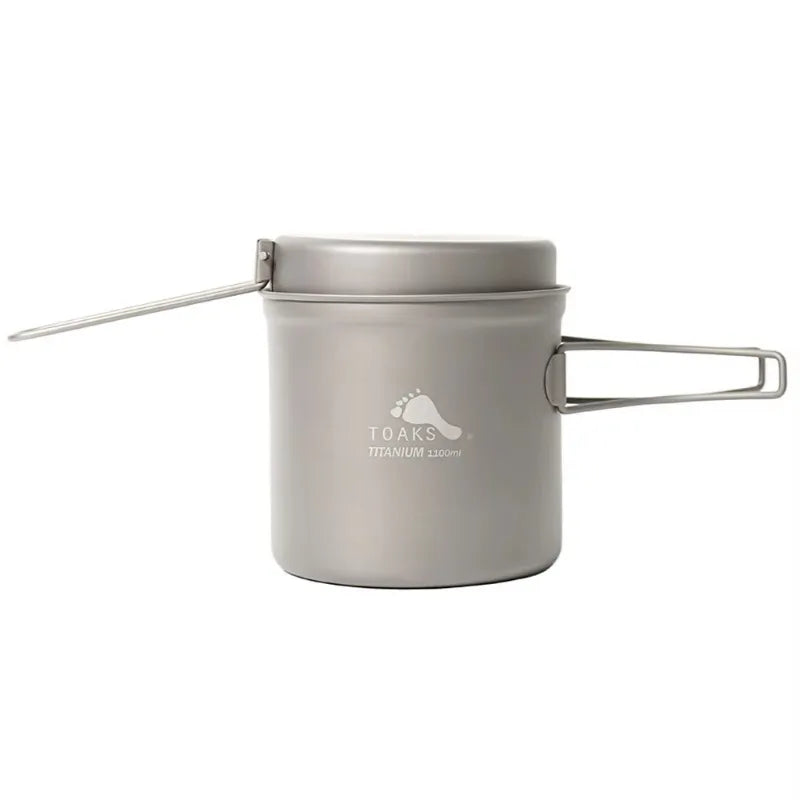 Titanium cookware set with lid and handles on a white background