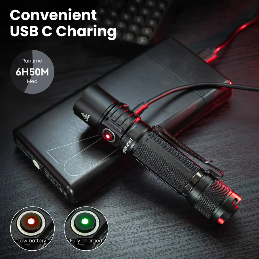 Black flashlight with USB cable charging on a dark surface, showing charging indicators.