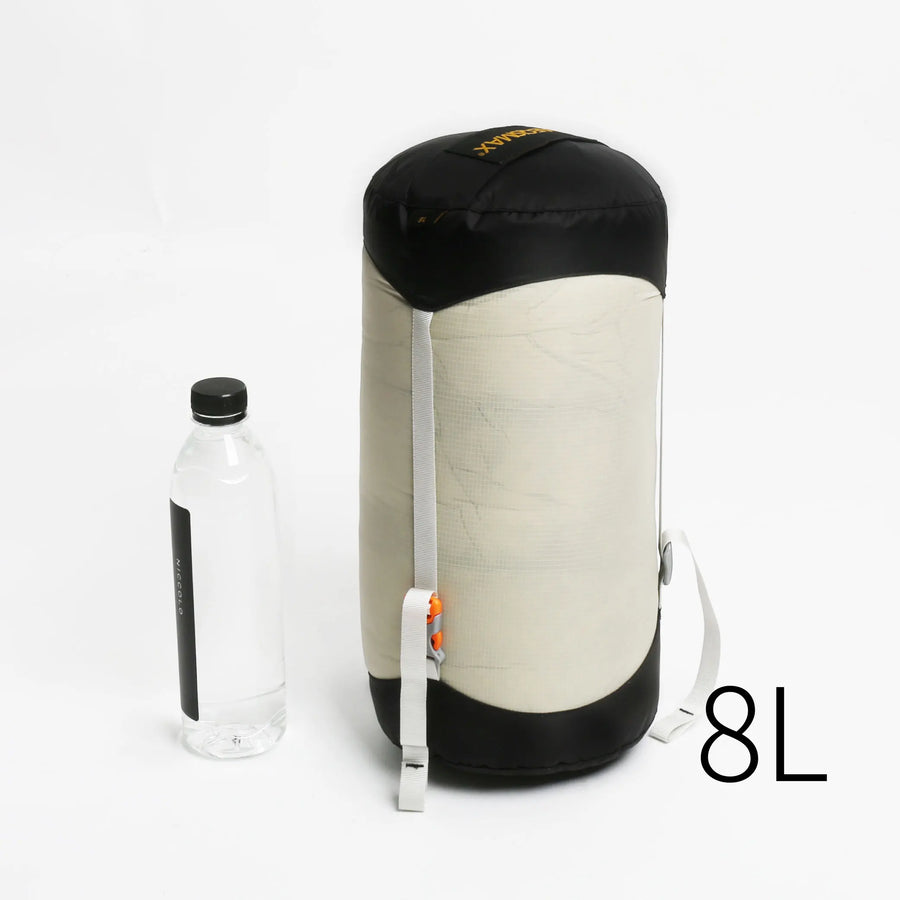 Compact sleeping bag with a water bottle on a white background