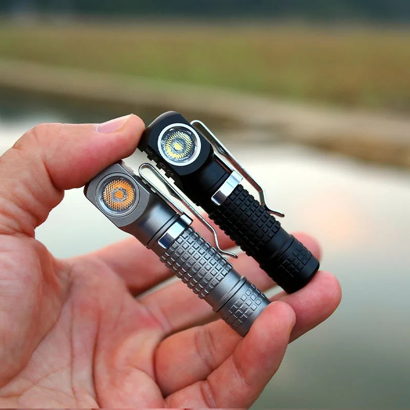 Hand holding two flashlights on a blurred natural background