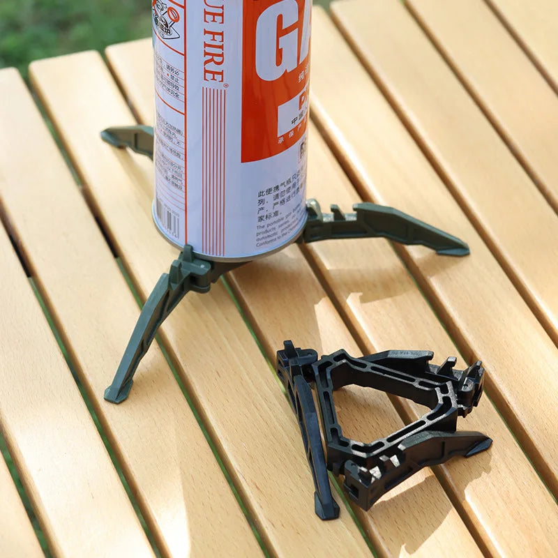Portable gas stove with canister holder on a wooden surface