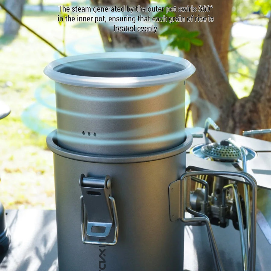 Portable stove with a pot on top, set outdoors with trees and grass in the background.