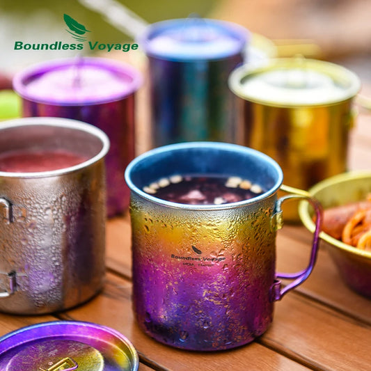 Colorful metal mugs with gradient finishes on a wooden surface, featuring 'Boundless Voyage' branding.