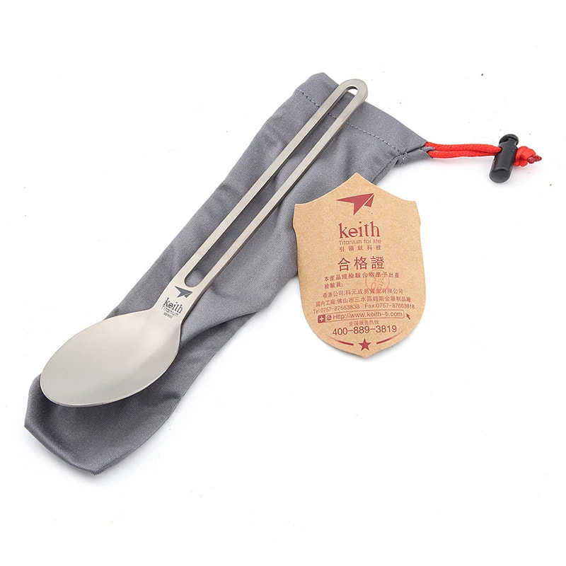 titanium spoon with a tag on a gray cloth background