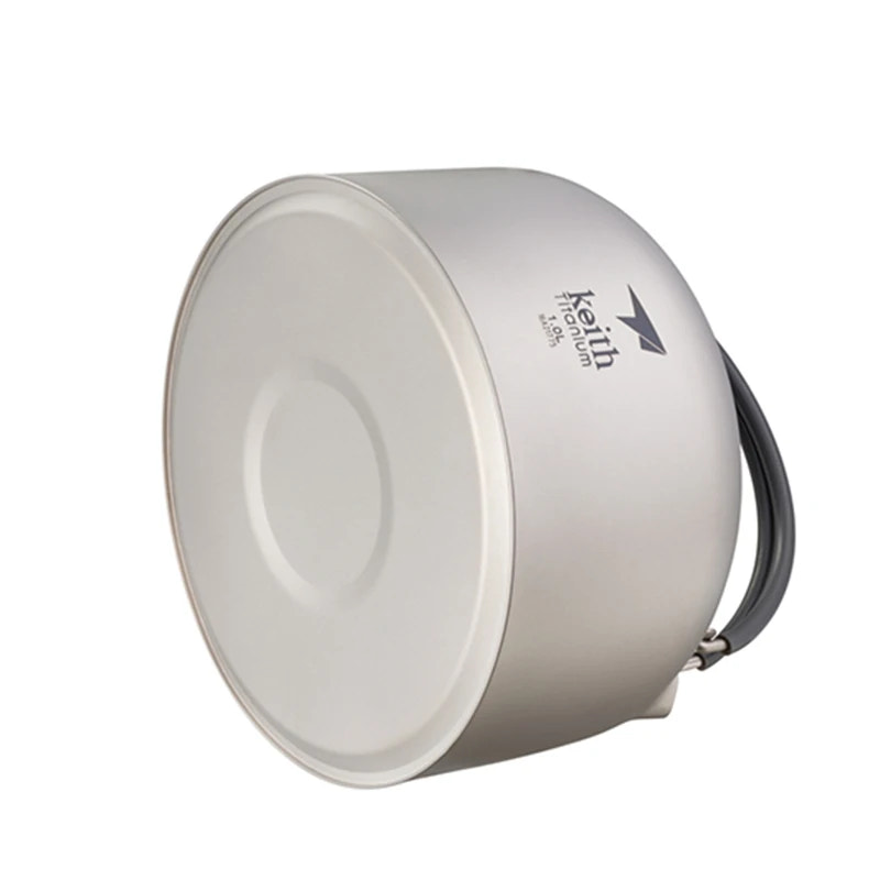 titanium camping pot with a handle on a white background