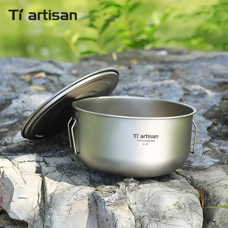 Titanium pot with lid on a rock, Tiartisan brand visible