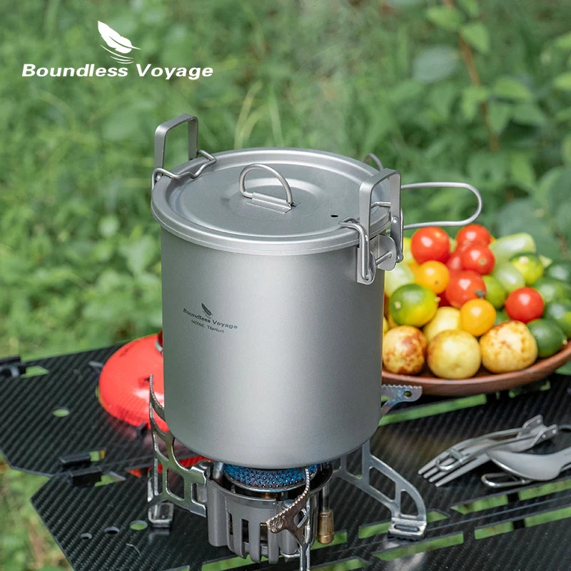 Camping stove with pot on a grill, surrounded by fresh vegetables, with 'Boundless Voyage' branding.