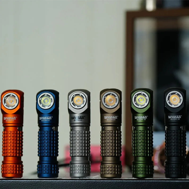 Six flashlights in different colors on a gray surface with a blurred background