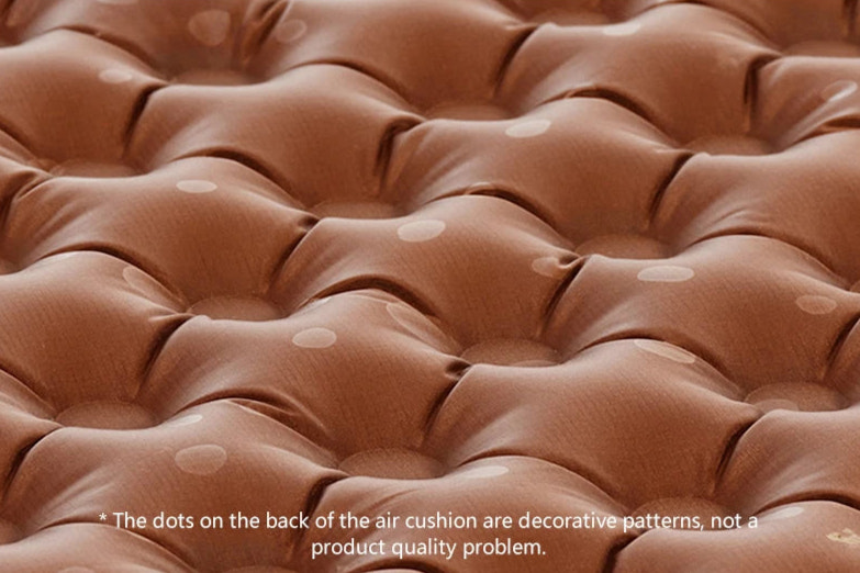 Close-up of a brown air mattress with decorative dots on the back.