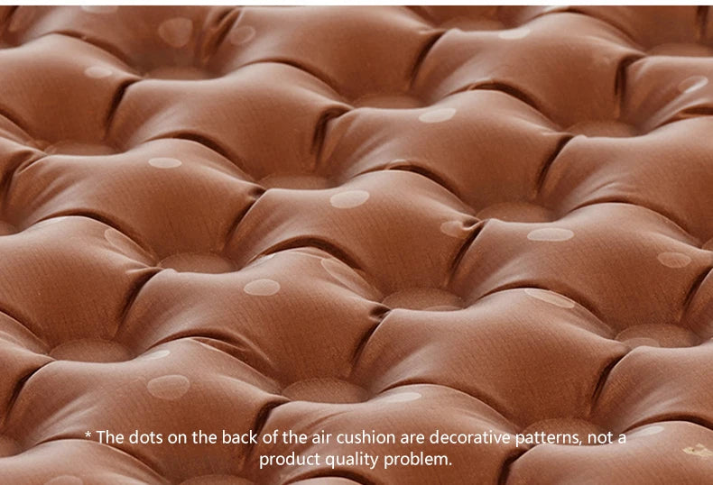 Close-up of a brown air mattress with decorative dots on the back.