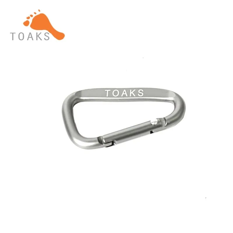 Silver carabiner with 'TOAKS' branding on a white background