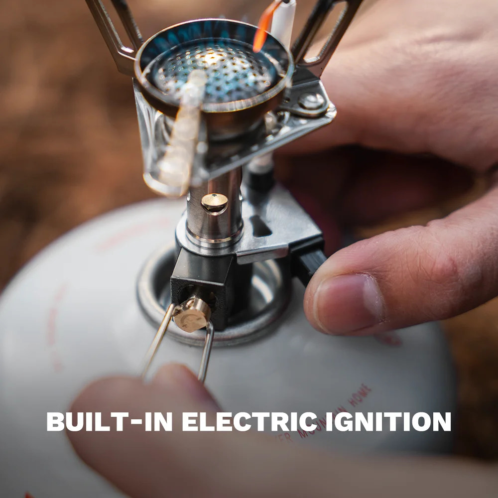 Person using a built-in electric ignition on a camping stove