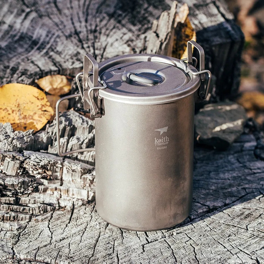 Titanium cook pot with lid on a wooden surface