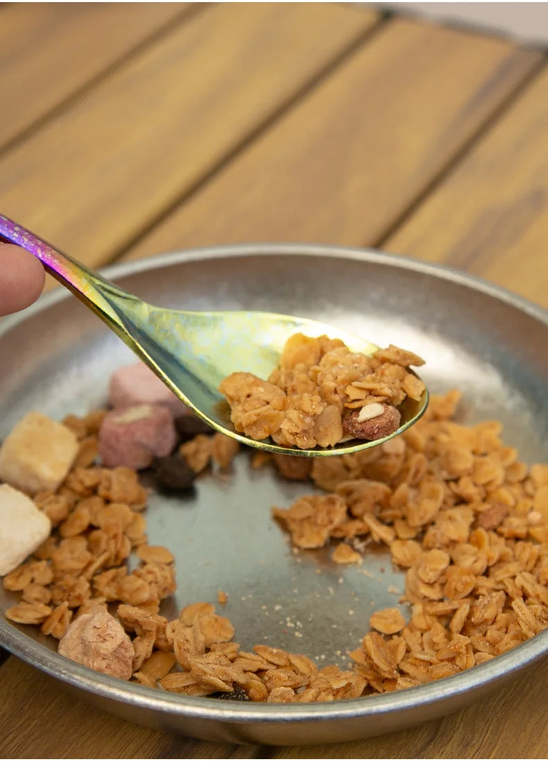 Spoonful of cereal over a metal bowl on a wooden surface