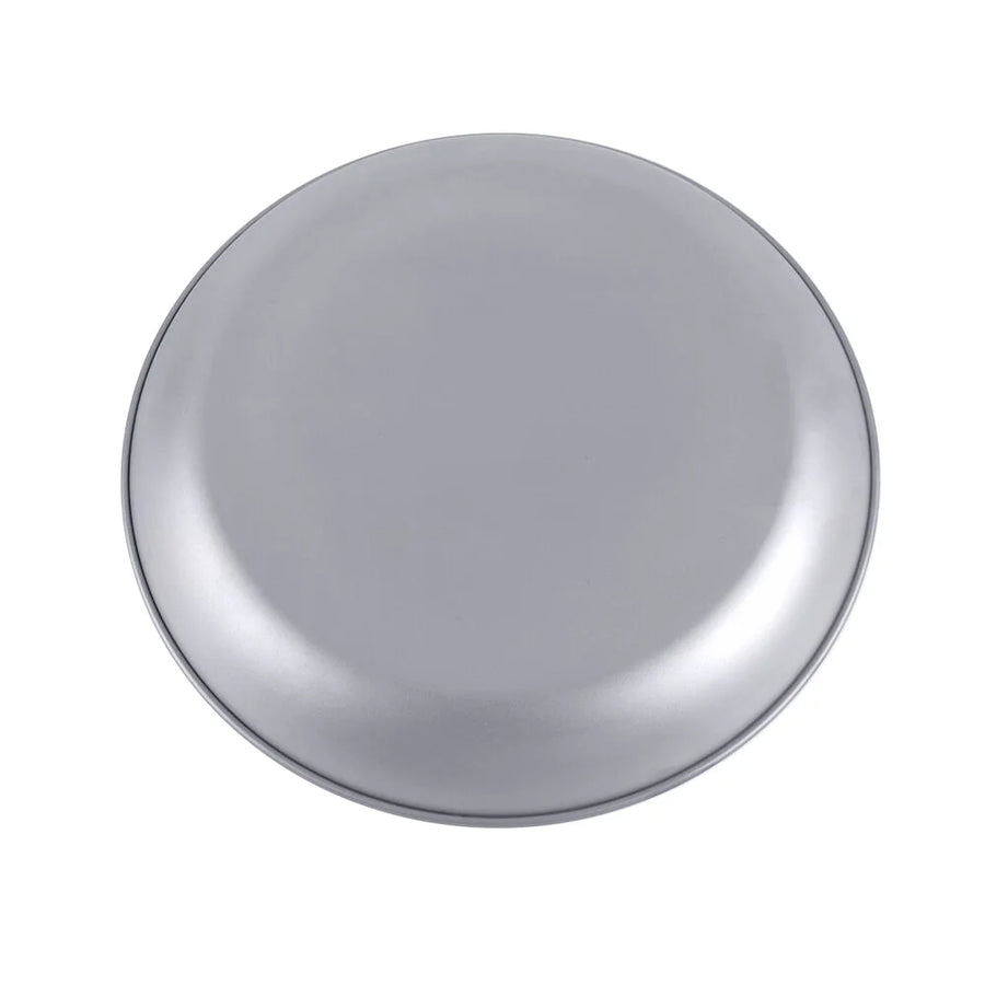 Round metallic object on a white background