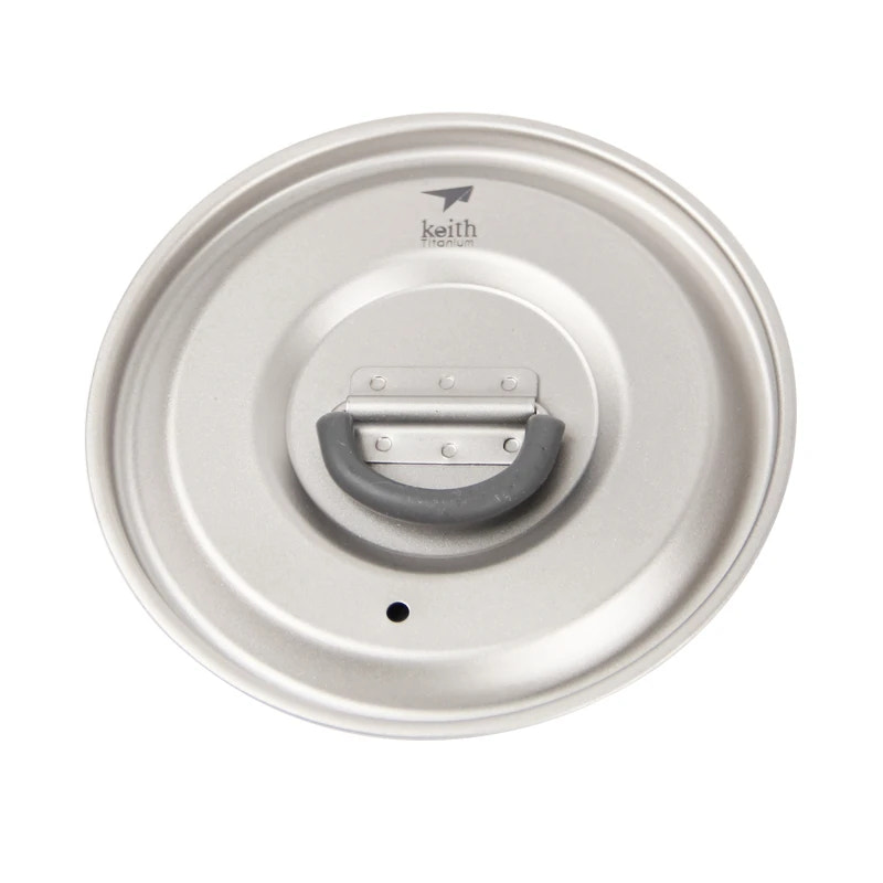 Metallic lid with a handle on a white background