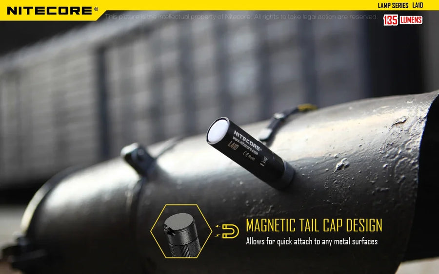 Nitecore flashlight with magnetic tail cap design on a metal surface