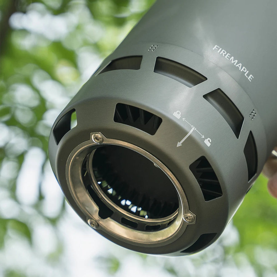 Close-up of a heat exchanger pot with 'Firemaple' branding against a blurred natural background.