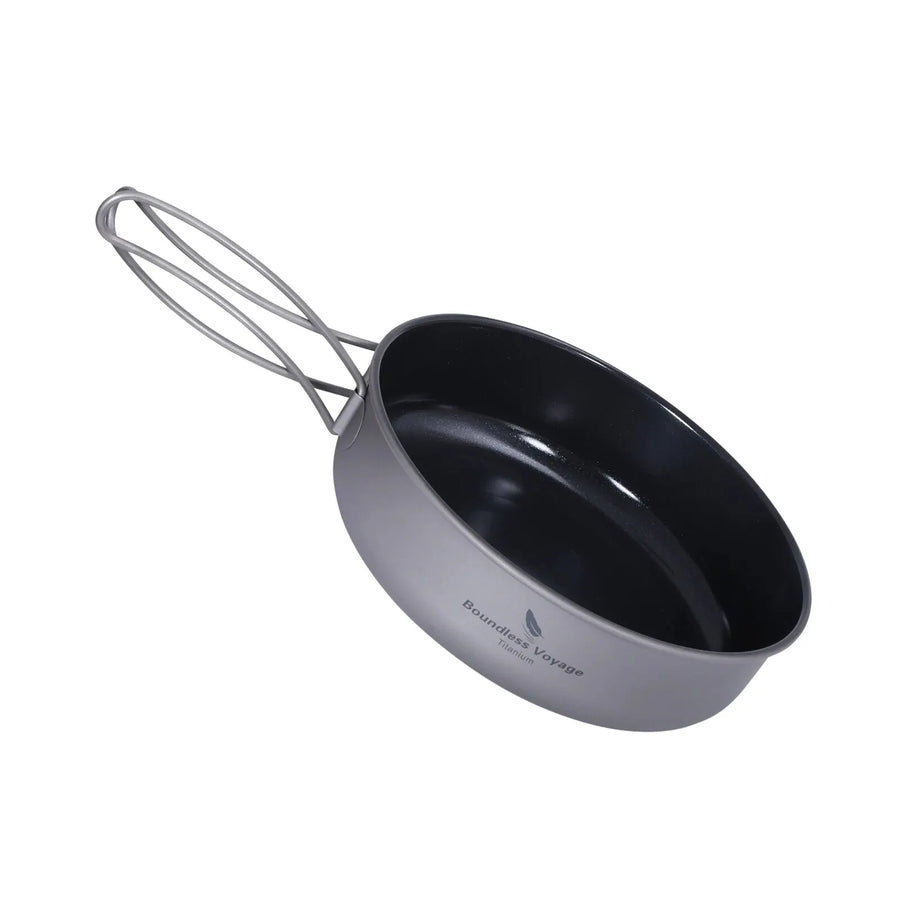 Black and gray camping pot with handle on a white background