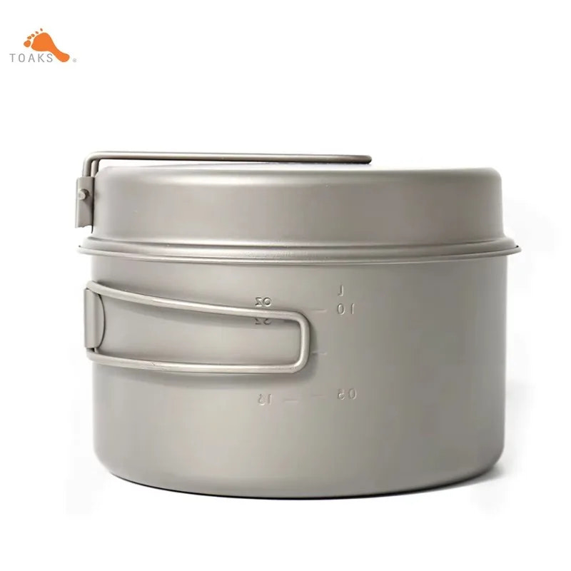 Metal camping pot with handles on a white background, featuring the Toaks brand logo.