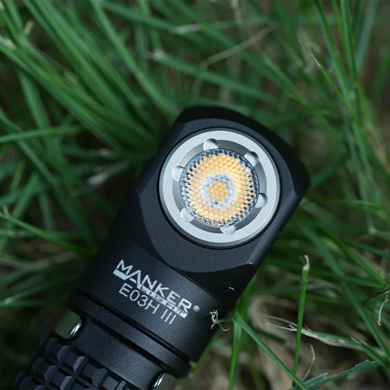 Manker E03H III flashlight on grass