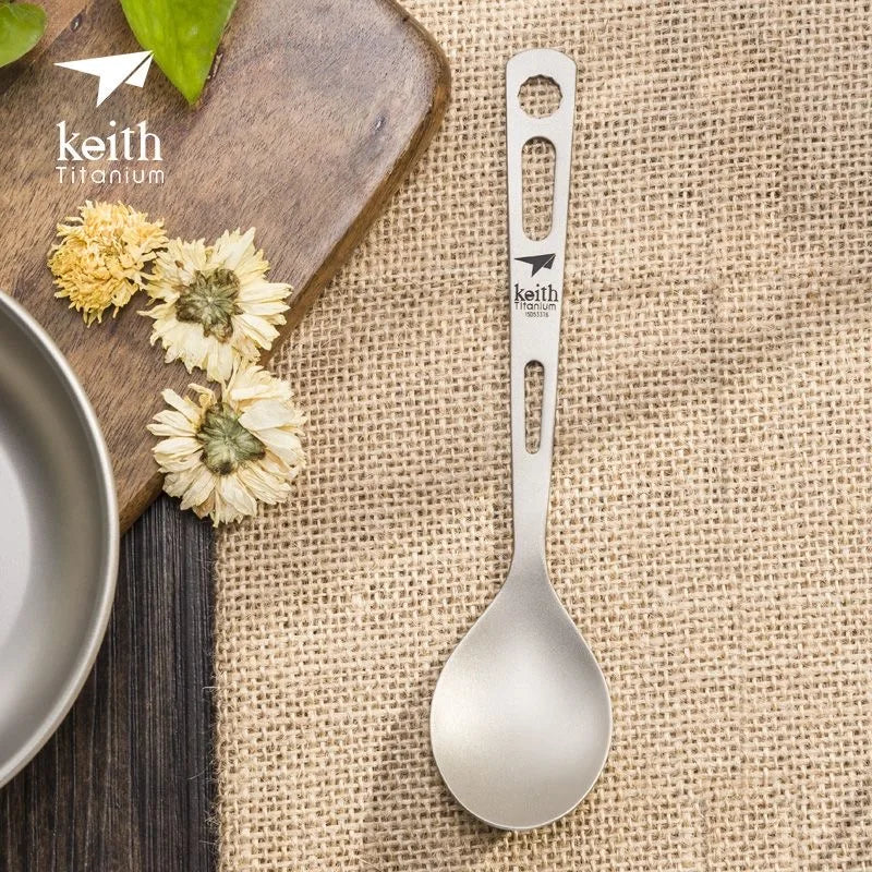 Keith Titanium spoon on a rustic background with flowers and a cutting board.