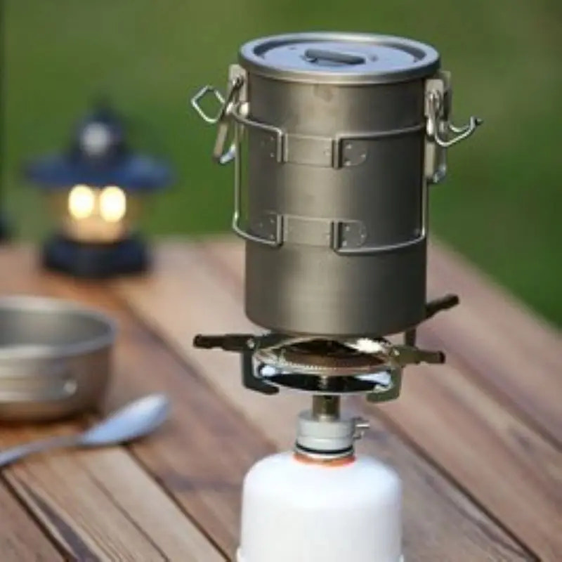 Portable camping stove on a wooden surface with a blurred background