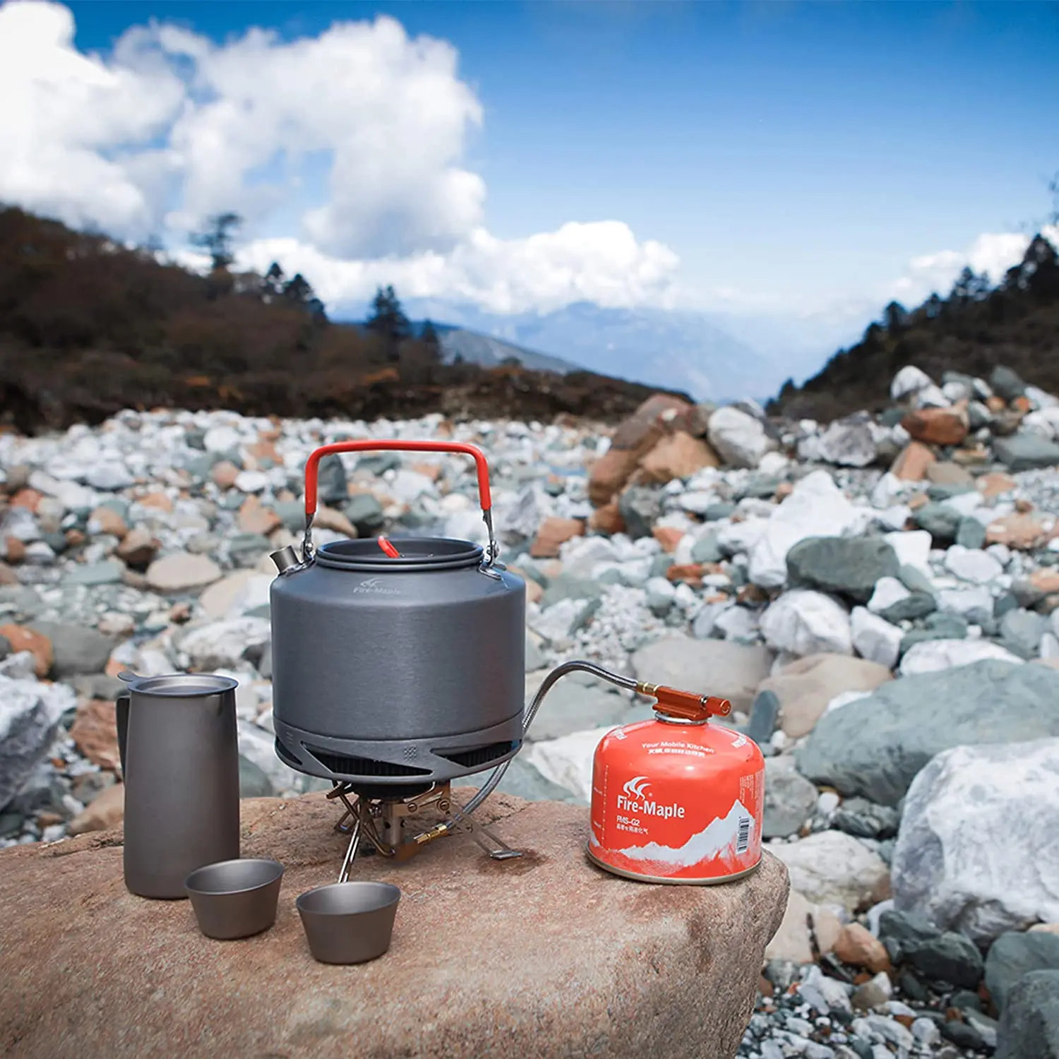 Camping stove with accessories on a rocky landscape