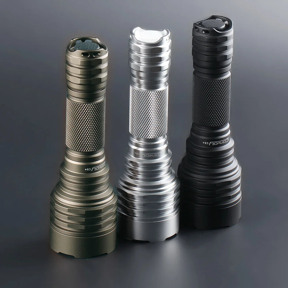 Three flashlights of different designs on a gray background